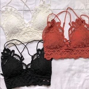 Three bralettes white black and coral